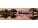 Tranquil community lake with fountain at sunset at 10449 Larchmont N Pl, Pinellas Park, FL 33782