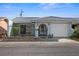 Light blue house with a white garage door, black gate, and landscaped yard at 10449 Larchmont N Pl, Pinellas Park, FL 33782