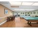 Bright game room with ping pong table, pool table, tables and chairs for residents to enjoy at 10449 Larchmont N Pl, Pinellas Park, FL 33782