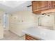 View of kitchen and hallway with tile floors and neutral walls at 10449 Larchmont N Pl, Pinellas Park, FL 33782