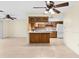 Kitchen with wood cabinets, breakfast bar, and tile flooring at 10449 Larchmont N Pl, Pinellas Park, FL 33782