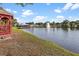 Quaint gazebo overlooks a serene lake with fountain at 10449 Larchmont N Pl, Pinellas Park, FL 33782