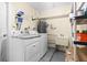 Laundry room with washer, dryer, utility sink, and storage shelves at 10449 Larchmont N Pl, Pinellas Park, FL 33782