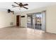 Spacious living room with tile floors and two ceiling fans at 10449 Larchmont N Pl, Pinellas Park, FL 33782
