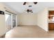 Open living space with tile floors, ceiling fan and access to the patio at 10449 Larchmont N Pl, Pinellas Park, FL 33782