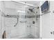 Walk-in shower with grab bars and pebble tile details at 10449 Larchmont N Pl, Pinellas Park, FL 33782