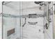Large walk-in shower with bench seat and multiple shower heads at 10449 Larchmont N Pl, Pinellas Park, FL 33782