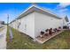 Landscaped side yard with potted plants and gravel at 10449 Larchmont N Pl, Pinellas Park, FL 33782