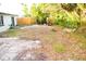 Spacious backyard with mature trees and a wooden fence at 11300 Yellowwood Ln, Port Richey, FL 34668