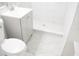 Renovated bathroom, featuring a gray vanity and marble-tiled shower at 11300 Yellowwood Ln, Port Richey, FL 34668