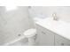 Updated bathroom with gray vanity and marble-tiled shower at 11300 Yellowwood Ln, Port Richey, FL 34668