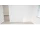 Simple bedroom with an open doorway and light wood-look flooring at 11300 Yellowwood Ln, Port Richey, FL 34668