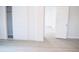 Bright bedroom with white sliding door closet and wood-look flooring at 11300 Yellowwood Ln, Port Richey, FL 34668