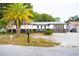 House exterior featuring a two-tone color scheme and a spacious driveway at 11300 Yellowwood Ln, Port Richey, FL 34668