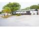 House exterior with two-tone color scheme, palm tree, and driveway at 11300 Yellowwood Ln, Port Richey, FL 34668