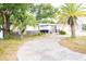 House exterior showcasing a two-tone color scheme and a palm tree at 11300 Yellowwood Ln, Port Richey, FL 34668