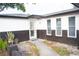 Front entrance with a white door and a walkway at 11300 Yellowwood Ln, Port Richey, FL 34668
