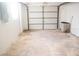Empty garage with overhead door and concrete floor at 11300 Yellowwood Ln, Port Richey, FL 34668