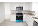 Renovated kitchen featuring granite countertops and stainless steel appliances at 11300 Yellowwood Ln, Port Richey, FL 34668