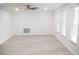 Bright living room with ceiling fan and new flooring at 11300 Yellowwood Ln, Port Richey, FL 34668