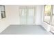 Bright sunroom with sliding glass doors and gray flooring at 11300 Yellowwood Ln, Port Richey, FL 34668