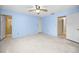 Large bedroom with light blue walls and ceiling fan at 1136 Burke Ave, Dunedin, FL 34698