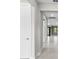 Hallway with neutral walls, baseboards, tile flooring, and recessed lighting at 17077 Moonflower Dr, Venice, FL 34293