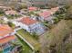 An aerial shot of a home with a screened-in pool, complemented by a well-maintained yard and neighboring houses at 22847 Sonoma Ln, Lutz, FL 33549