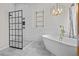 Bright bathroom featuring a soaking tub, glass shower enclosure, modern lighting and fixtures throughout at 22847 Sonoma Ln, Lutz, FL 33549
