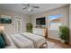 Cozy bedroom with a queen-size bed, dresser, and large window at 22847 Sonoma Ln, Lutz, FL 33549