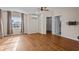 Open bedroom with beautiful hardwood floors, a ceiling fan, bright window, and access to the laundry room at 22847 Sonoma Ln, Lutz, FL 33549