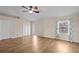 Bright primary bedroom featuring wood floors, double closets, and an ensuite bathroom at 22847 Sonoma Ln, Lutz, FL 33549