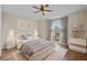 Serene bedroom featuring hardwood floors, a ceiling fan, and a large window with natural light at 22847 Sonoma Ln, Lutz, FL 33549