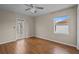 Inviting bedroom with hardwood floors, modern ceiling fan, and a private balcony with beautiful views at 22847 Sonoma Ln, Lutz, FL 33549