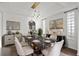 Stylish dining room featuring a marble table, modern furnishings, and beautiful decor at 22847 Sonoma Ln, Lutz, FL 33549