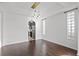 Elegant dining room with modern lighting fixtures, dark wood floors, and kitchen view at 22847 Sonoma Ln, Lutz, FL 33549