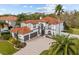 Beautiful two-story home with a red-tiled roof, lush landscaping, a paver driveway, and a two-car garage at 22847 Sonoma Ln, Lutz, FL 33549