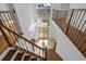 Elegant foyer with wood and iron staircase, tile flooring, and decorative front doors with a transom at 22847 Sonoma Ln, Lutz, FL 33549