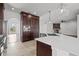 Open kitchen featuring a large island, custom cabinets, and stainless steel appliances at 22847 Sonoma Ln, Lutz, FL 33549