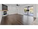 Spacious living room with wood floors, a fireplace, and sliding doors leading to an outdoor space at 22847 Sonoma Ln, Lutz, FL 33549