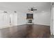 Spacious living room with a modern fireplace, dark wood floors, and lots of natural light at 22847 Sonoma Ln, Lutz, FL 33549