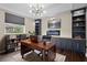 Bright, fully furnished home office with custom built-ins, sleek electric fireplace, and lots of natural light at 22847 Sonoma Ln, Lutz, FL 33549