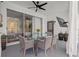 Covered patio with a glass-topped dining table, comfortable seating, and a mounted television at 22847 Sonoma Ln, Lutz, FL 33549