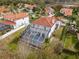 Aerial view showcasing a white home with a large screened pool, patio and a well-kept lawn at 22847 Sonoma Ln, Lutz, FL 33549
