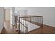Staircase with wood flooring, decorative wrought iron spindles, and natural light at 22847 Sonoma Ln, Lutz, FL 33549