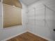 Simple walk-in closet with hardwood floors, a window, and wire shelving for easy organization at 22847 Sonoma Ln, Lutz, FL 33549