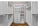 Spacious walk-in closet with custom shelving, drawers and hanging space for optimal storage and organization at 22847 Sonoma Ln, Lutz, FL 33549