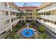 Inviting courtyard with a fountain and lush tropical plants at 2650 Pearce Dr # 301, Clearwater, FL 33764