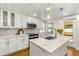 Bright kitchen with white cabinets, quartz countertops, and stainless steel appliances at 4304 W Fair Oaks Ave, Tampa, FL 33611