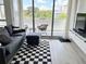 Living room features gray sofa and checkerboard rug at 470 3Rd S St # 405, St Petersburg, FL 33701